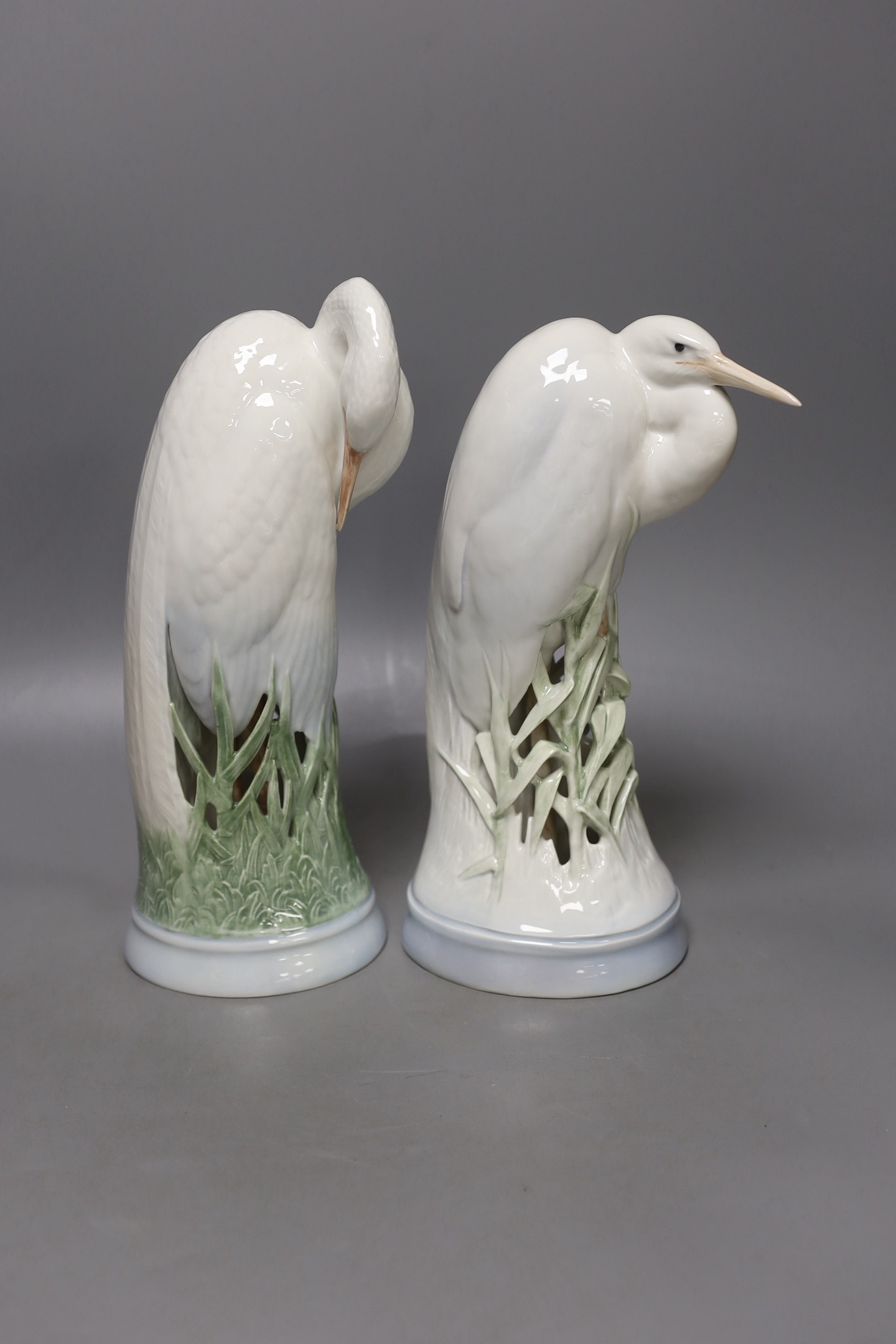 Two Royal Copenhagen figures of herons, model number 3002 and 532, 28 cms high.